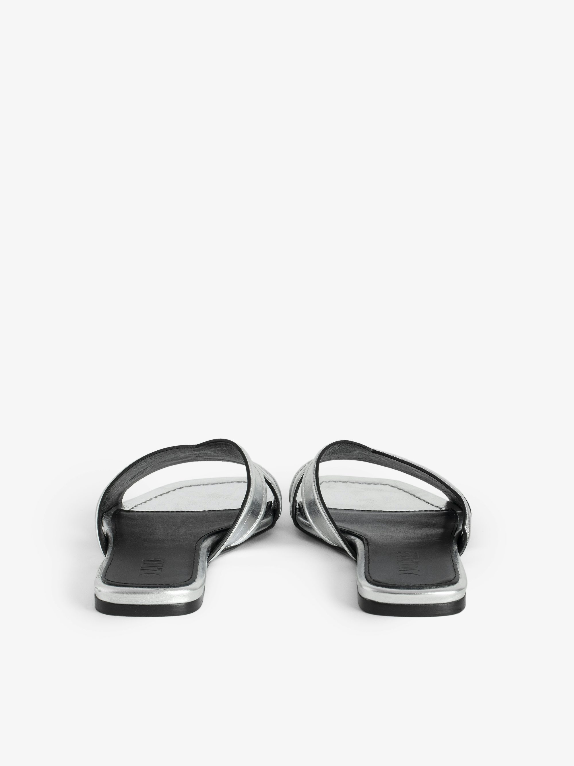 Azora Mules - A harmonious blend of edgy design and luxurious craftsmanship. These mules feature a metallic crinkled leather exterior, exuding a bold yet sophisticated allure. The embossed signature wings add a distinctive touch, embodying the brand's rebellious spirit. Designed with a square toe and crossover strap at the toe, they offer both style and comfort.